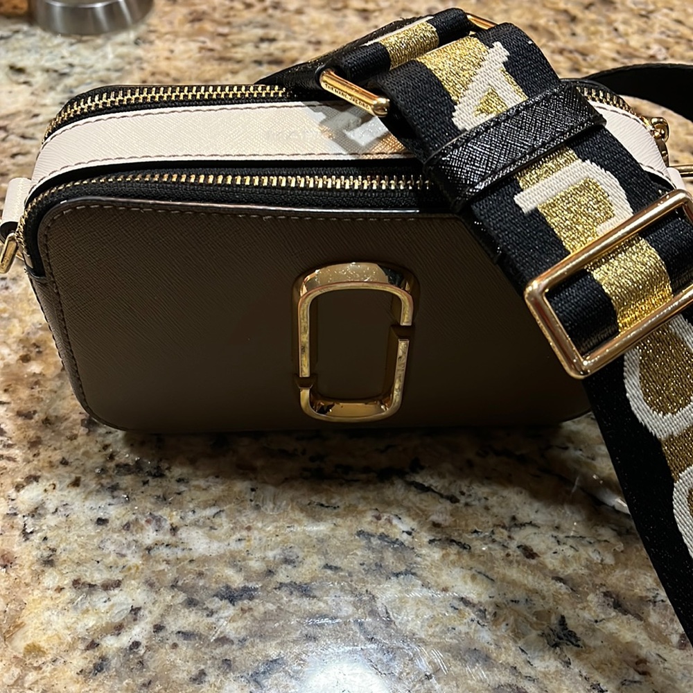 This product is a Marc Jacobs handbag or crossover bag gently worn no stains.